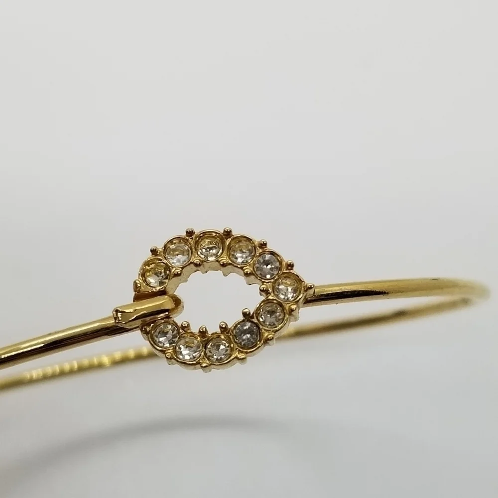 gold tone bracelet with pave rhinestone teardrop clasp